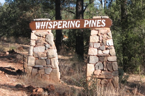 whispering pines road sign